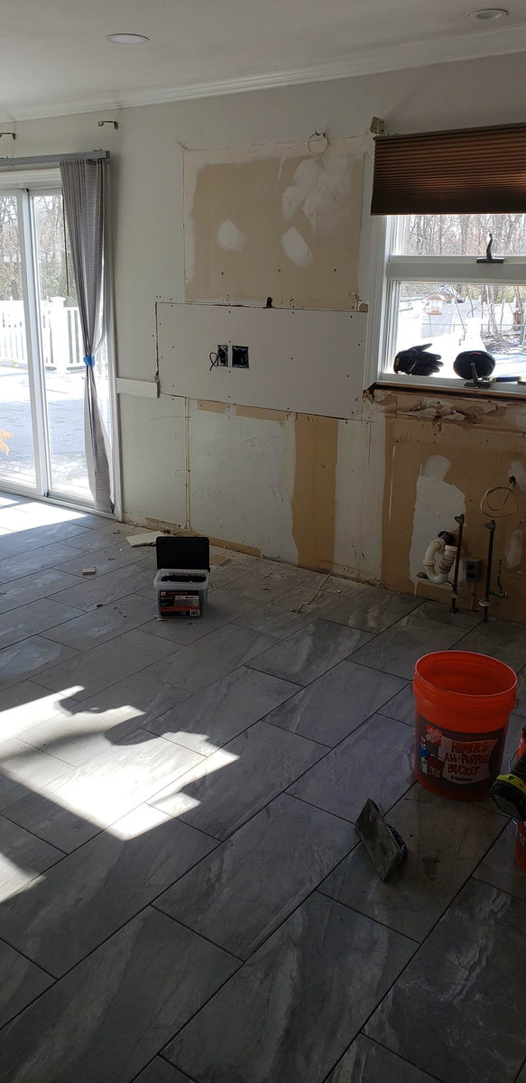Kitchen stripped back to bare drywall with cabinets and countertops removed