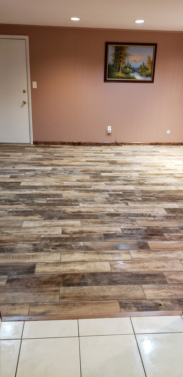 Wood-look plank tile floor laid wall to wall in a living room