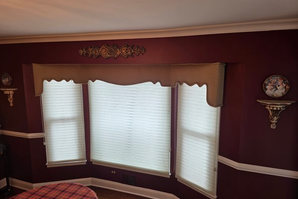Dining room painted deep burgundy above and below a white chair rail, with white crown moulding and window trim