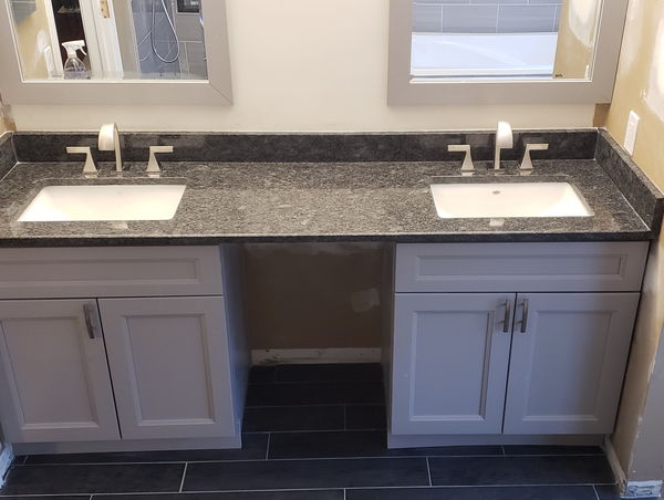 Double vanity with a granite top, two undermount sinks and brushed nickel taps