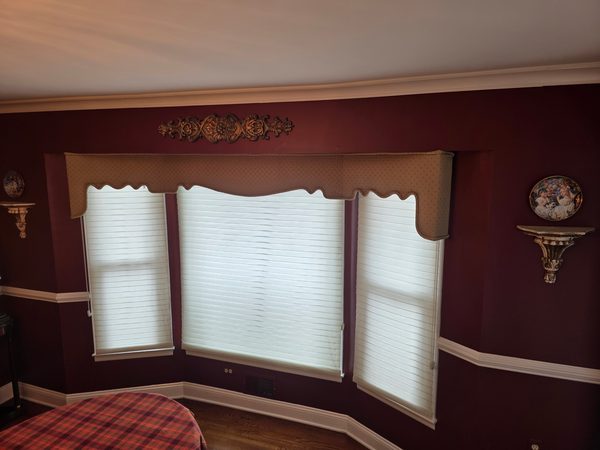 Dining room painted deep burgundy above and below a white chair rail, with white crown moulding and window trim