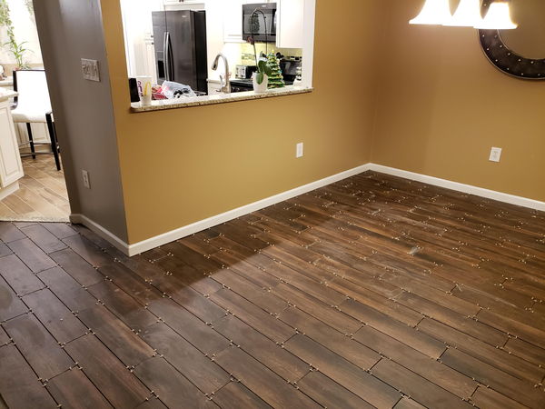 Wood-look floor tile laid on the diagonal through an empty room
